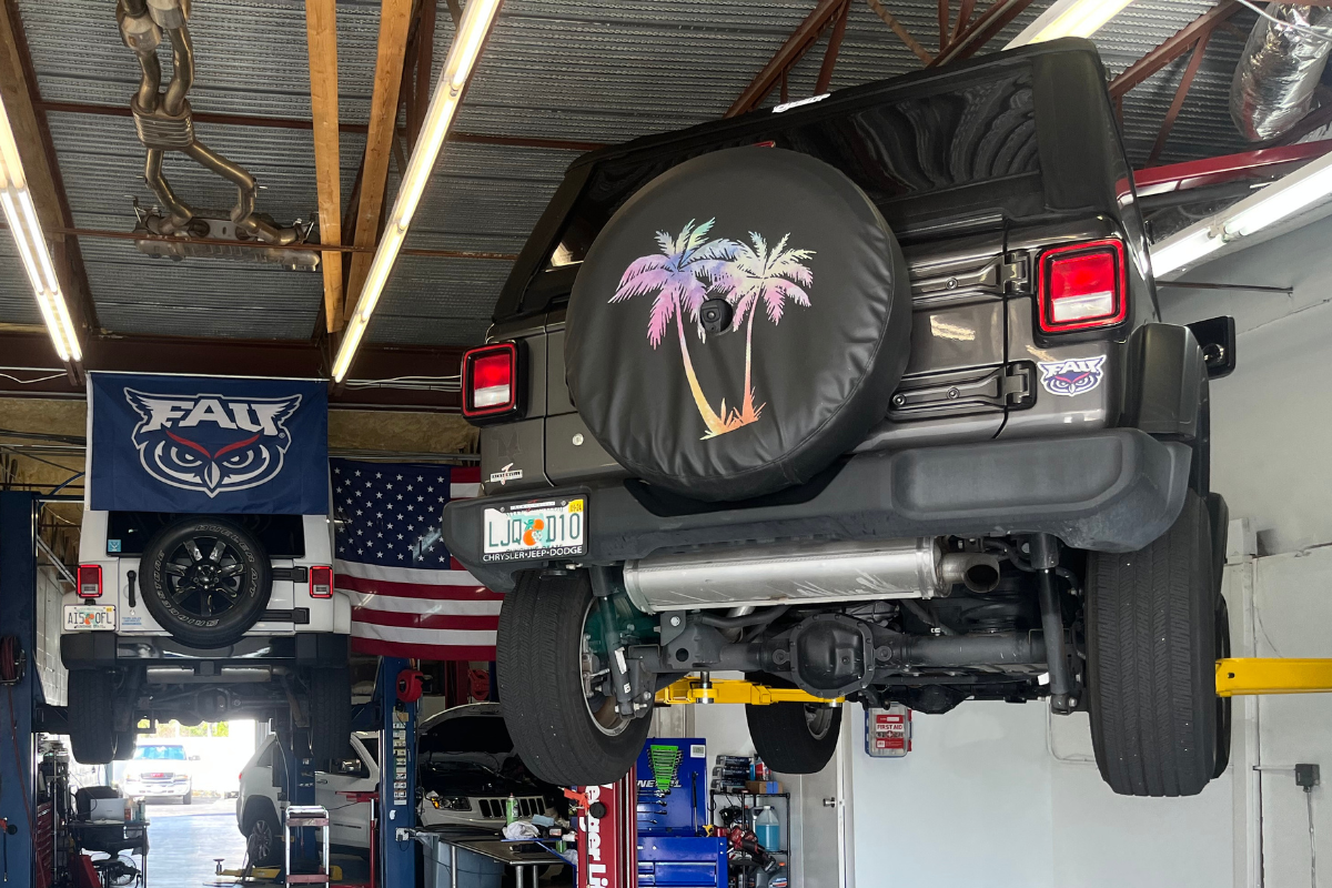 jeep repair and maintenance near me in boca raton, fl by boca auto fix. image of 2 chrysler jeep dodge vehicles being lifted for jeep repair and preventative maintenance.