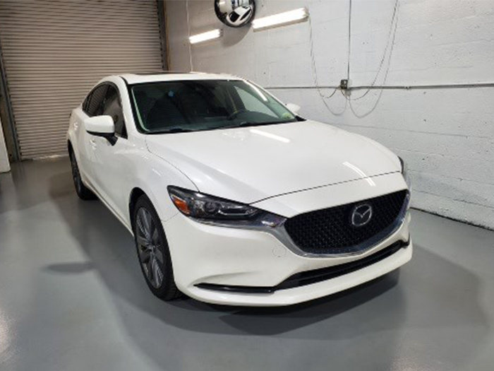 white mazda inside boca auto shop