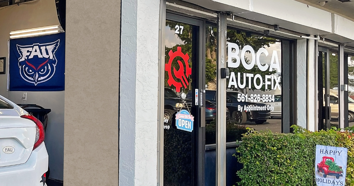 fau’s trusted repair shop in boca raton, fl. image showing the exterior of boca auto fix, with a florida atlantic university (fau) flag visible inside the shop, highlighting the connection to the fau community and the welcoming environment for students seeking reliable car maintenance and repair services.