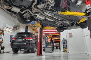 drop-off only, auto repair in Boca Raton, FL at Boca Auto Fix. Multiple vehicles on lifts inside a clean and organized auto repair facility, emphasizing advanced repair and maintenance services.
