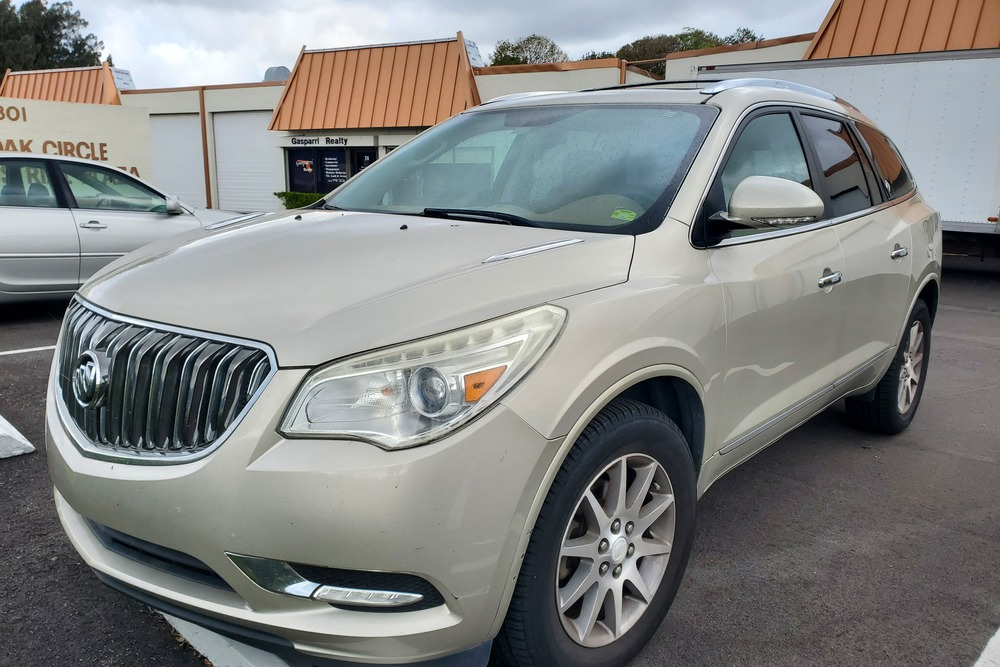 Buick Auto Repair in Boca Raton, FL - Boca Auto Fix Metallic beige SUV parked in a lot with a chrome grille and tinted windows.
