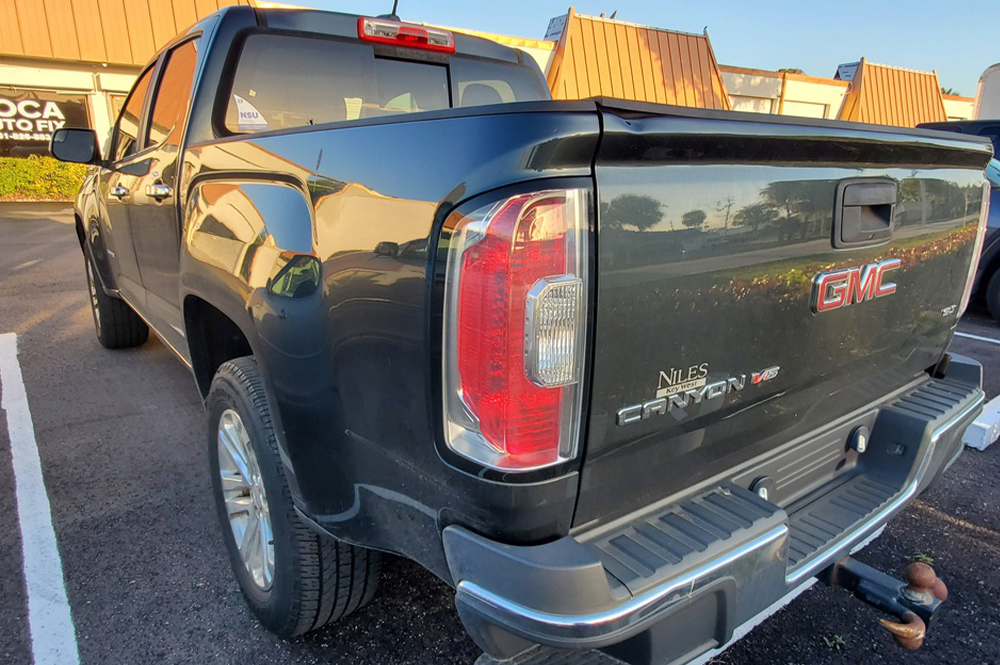 GMC Auto Repair in Boca Raton, FL - Boca Auto Fix gmc auto repair in Boca Raton, FL at Boca Auto Fix. A black GMC truck parked outside of an auto repair shop.
