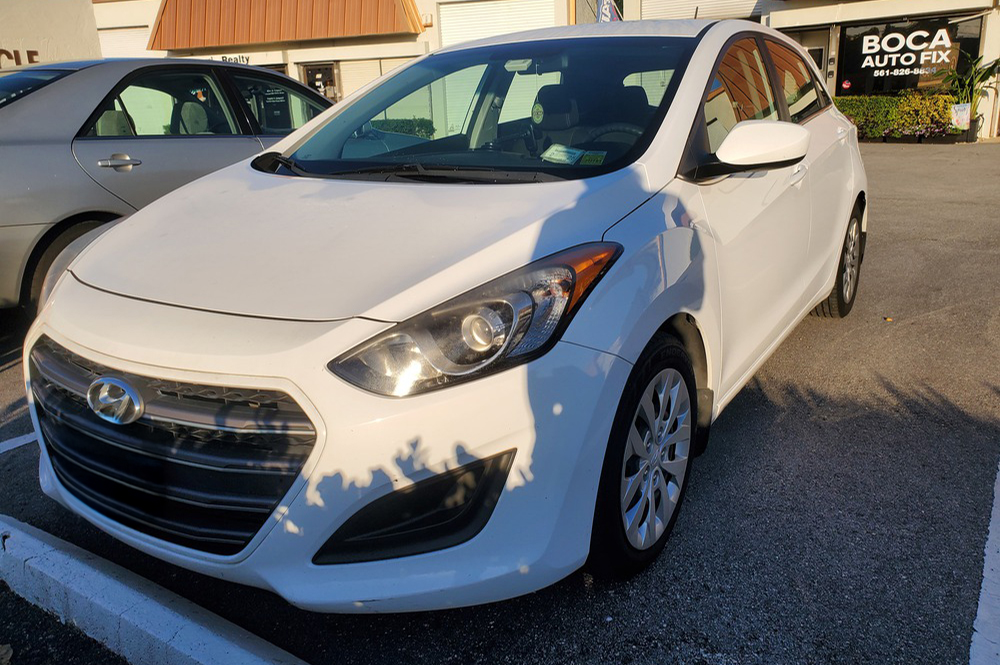 Hyundai auto repair in Boca Raton, FL at Boca Auto Fix. A white Hyundai vehicle parked outside of an auto repair shop.