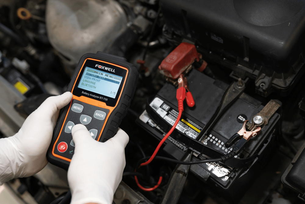 Car battery replacement in Boca Raton, FL by Boca Auto Fix. Image showing a mechanic using a diagnostic tool to test a car battery’s performance, ensuring reliable starts and preventing unexpected electrical issues.