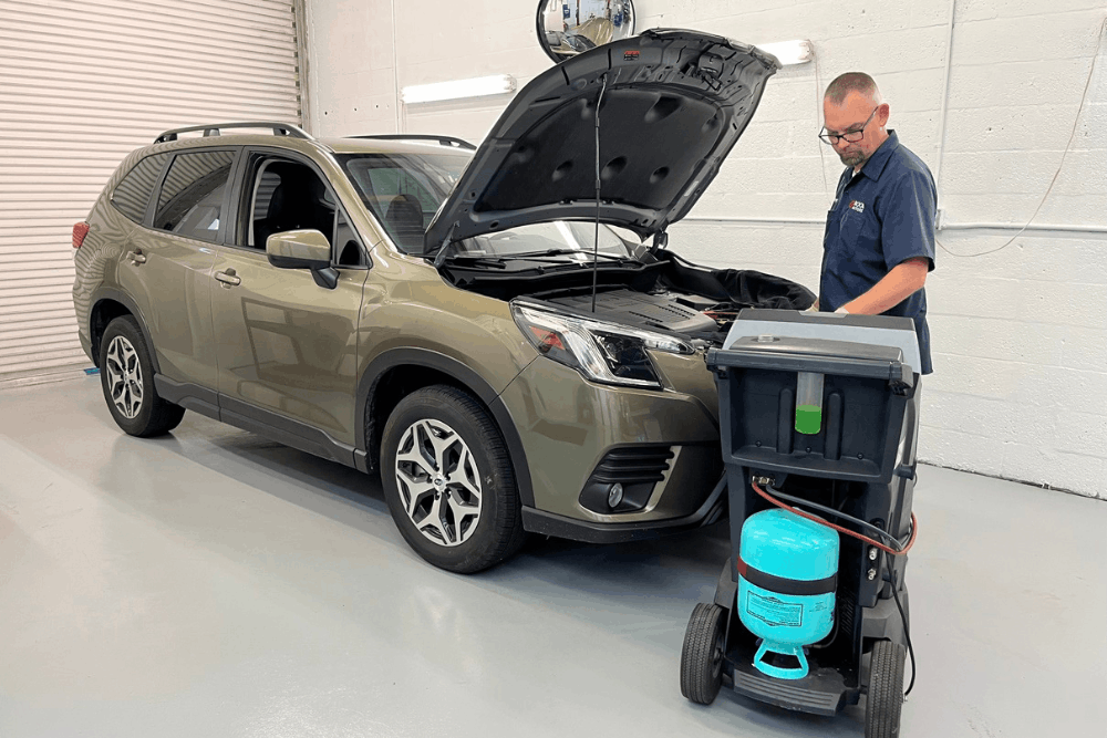 Auto a/c repair in Boca Raton, FL by Boca Auto Fix. Image of Doug DeLucca servicing a Subaru SUV with professional A/C equipment, highlighting precise diagnostics, refrigerant recharge, and reliable cooling performance for year-round comfort.