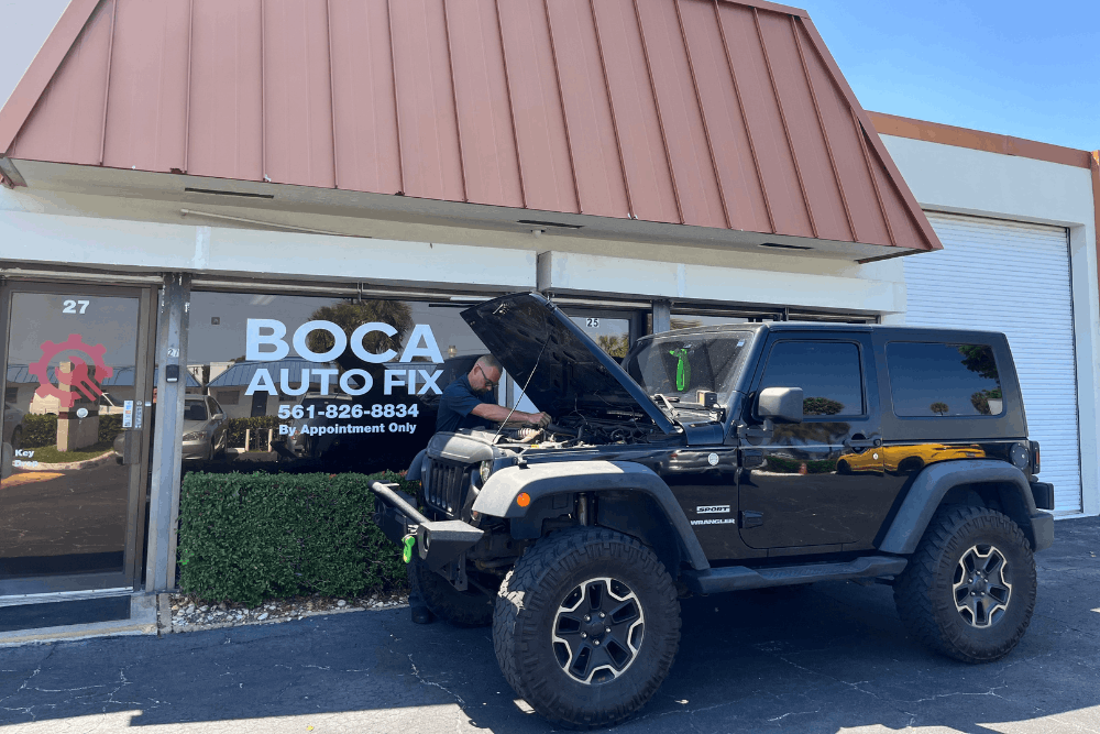 Car inspection, auto repair in Boca Raton, FL, at Boca Auto Fix. Image of Doug DeLucca inspecting a Jeep Wrangler receiving a pre-trip vehicle inspection outside Boca Auto Fix, highlighting professional maintenance services to prepare vehicles for safe and reliable road travel.