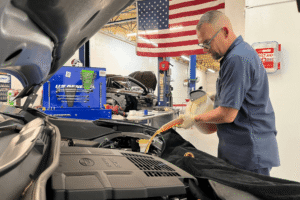 preventative maintenance, auto repair in boca raton, fl at boca auto fix. image of doug delucca adding fluid under the hood of a toyota to support proper maintenance and reliable vehicle performance.