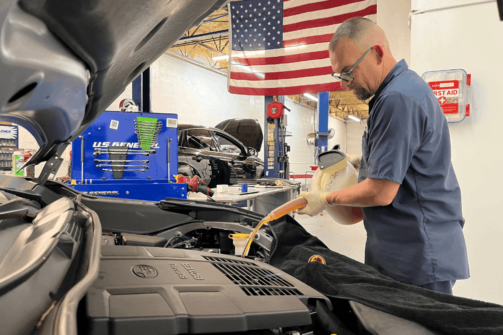 preventative maintenance, auto repair in boca raton, fl at boca auto fix. image of doug delucca adding fluid under the hood of a toyota to support proper maintenance and reliable vehicle performance.