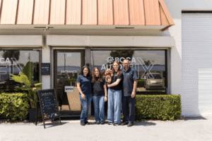 family-owned auto repair shop in boca raton, fl at boca auto fix. image of doug delucca and family standing outside the boca auto fix's shop entrance.