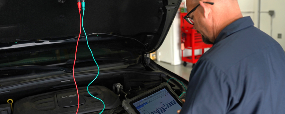 Doug DeLucca using diagnostic equipment on a vehicle.