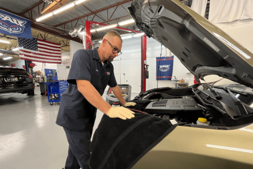cooling system repair, auto repair in Boca Raton, FL at Boca Auto Fix. Doug DeLucca inspecting a vehicle's engine bay.