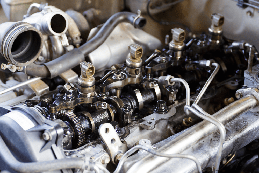 Boca Auto Fix – fuel system repair-min fuel system repair, auto repair in Boca Raton, FL at Boca Auto Fix. Image showing a close-up view of a disassembled engine fuel system with visible injectors and metal fuel lines.